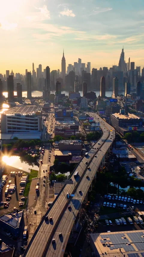 Golden hour traffic on elevated expressway toward Manhattan, New York Vertical Video stock 342273807