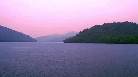 Golden hour view of Thane creek and hills under pink sky Видео 345110472