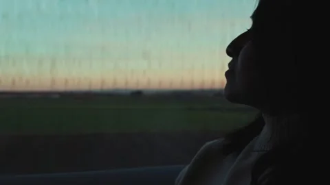 Golden hour view from a train window in Catalonia with a thoughtful woman. Stock Footage 305158052