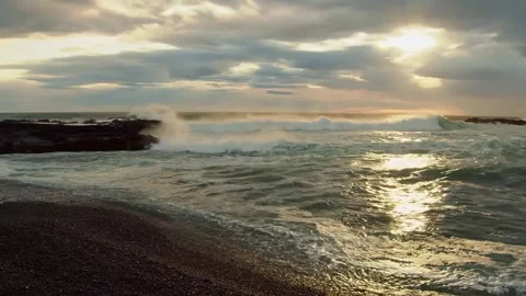 Golden Hour Waves Crash on a Black Sand Beach in Iceland Stock Footage 320229549