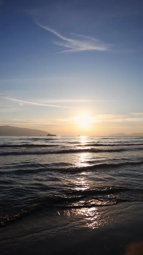Golden Hour Waves with Distant Ship Silhouette Stock Footage 331887892