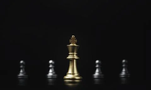 Golden of king chess in front of silver pawns chess for leadership concept. Stock Photos