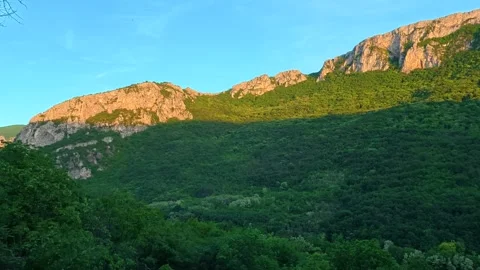 Golden light bathes forested mountainside. Sicevo Gorge, Serbia. Stock Footage 337052656