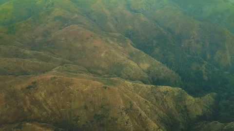 Golden light bathes rugged mountain ridgelines Stock Footage 341300769