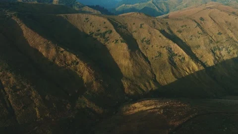 Golden light bathes rugged mountain ridgelines Stock Footage 341301577