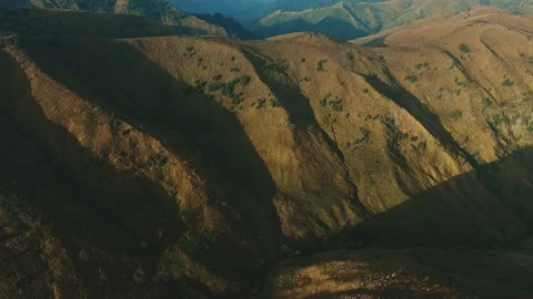 Golden light bathes rugged mountain ridgelines Stock Footage 341301720