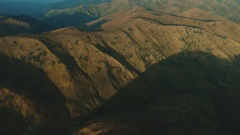 Golden light bathes rugged mountain ridgelines Stock Footage 341301833