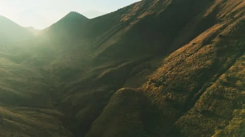 Golden light bathes rugged mountain ridgelines Stock Footage 341302913
