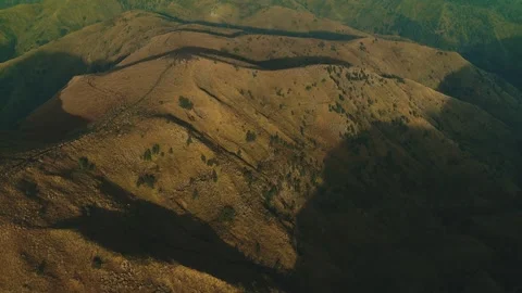 Golden light bathes rugged mountain ridgelines Stock Footage 341303012