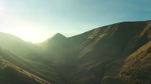 Golden light bathes rugged mountain ridgelines Stock Footage 341303286