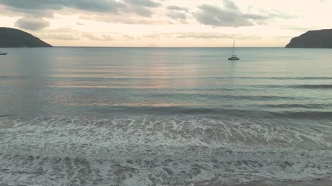 Golden Light on Beach – Warm Sunset Aerial over Shoreline (4K Drone) Stock Footage 310180918