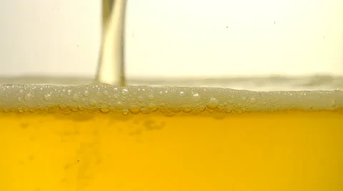 Golden light beer being poured into a glass Stock Footage 59910675