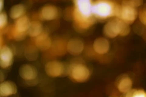 Golden light bokeh pattern creating an ethereal soft background effect Stock Photos