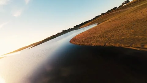 Golden light glows over calm water Video stock 342177158