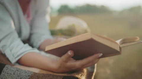 Golden Light on Hand Turning Book Page Outdoors Stock Footage 305014296