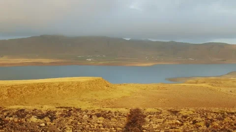 Golden Light over a Tranquil Lake in the Icelandic Highlands Stock Footage 320199500