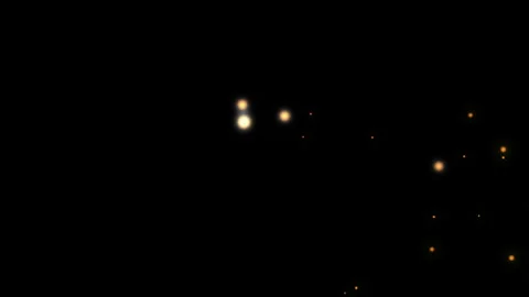 Golden light particles floating on a deep black background Stock Footage 343075379