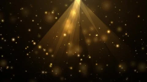 Golden light rays shining down with particles floating in dark background c.. Video stock 345003775