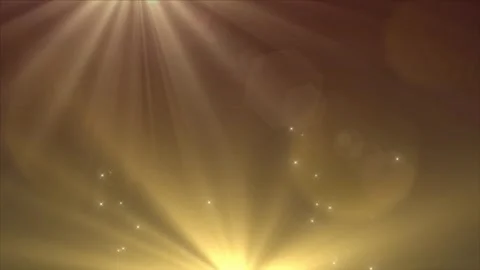Golden light rays shining with floating particles in a dark background with a Video stock 338437533
