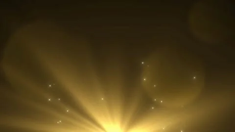 Golden light rays with sparkling particles and lens flare effect on a dark Stock Footage 337464854