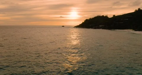 Golden light reflecting on ocean waters at dusk. Seychelles, Mahe. Stock Footage 322016471