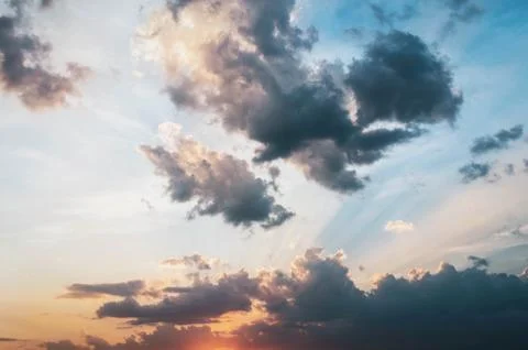 Golden light shining through the clouds in a colorful evening at sunset and.. Stock Photos