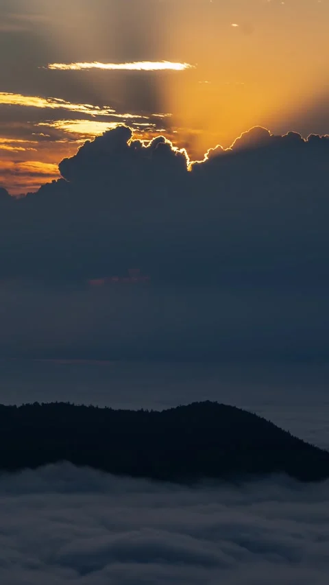 Golden Light of Sun at Sunrise with Dramatic Stormy Clouds Forming over Foggy Stock Footage 317651423