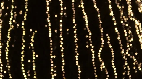 Golden lights against black background Stock Footage 244230863