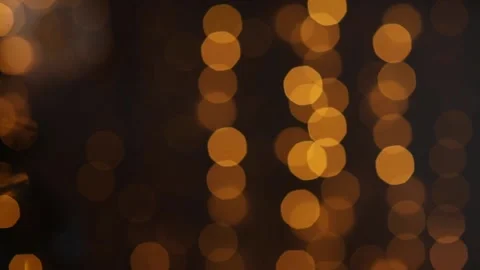 Golden lights flicker against a dark background, bokeh Stock Footage 165863832