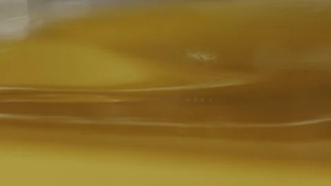 Golden liquid of high viscosity flows creating streams in different directions. Stock Footage 309951996