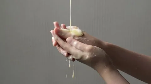 Golden liquid soap gracefully streams into hands, offering a moment of soot.. Stock Footage 304213386
