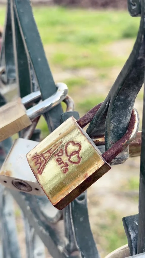 Golden love lock engraved with Eiffel Tower and two hearts, romantic tradition Stock Footage 340863219