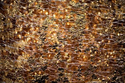 Golden luxury backdrop in abstract pattern. Golden reflective foil on shiny s Stock Photos