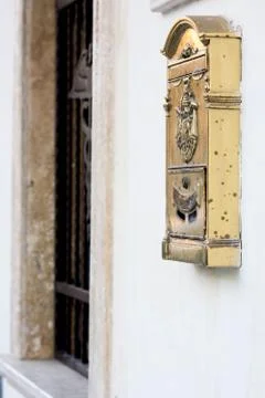 A golden mailbox on the wall Stock Photos
