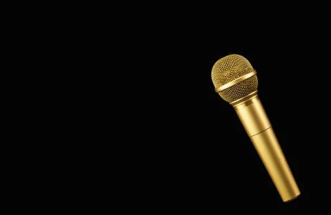 Golden microphone on black background. Stock Photos
