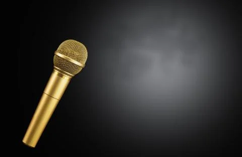 Golden microphone on black background. Stock Photos