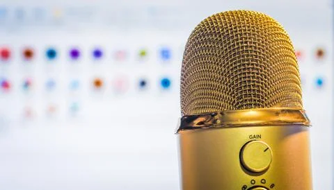Golden microphone close up with computer main screen background Stock Photos