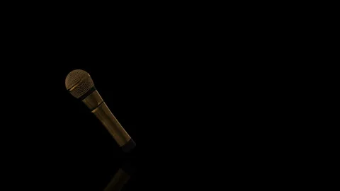 Golden Microphone turns on itself - loop animation - black background Video stock 255464261