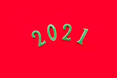Golden numbers 2021 on solid red background. New Year and Christmas concept. Stock Photos