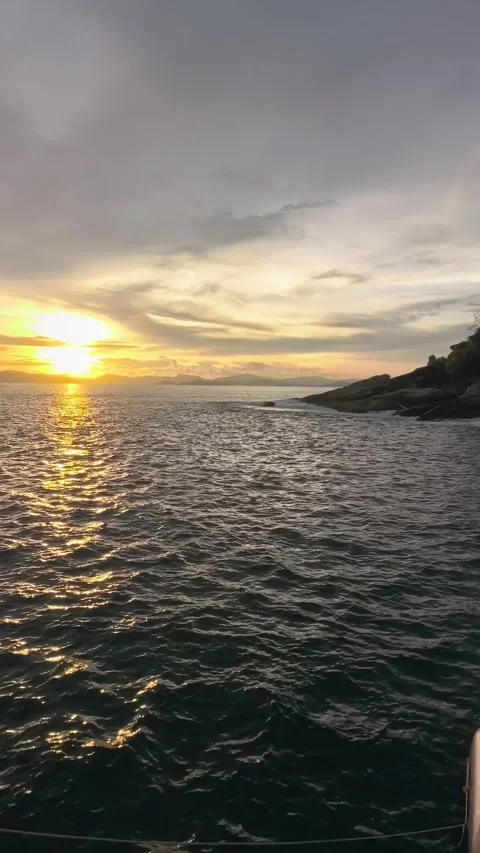Golden Ocean Sunset View from Boat Coasting Near Rocky Island Stock Footage 341008788