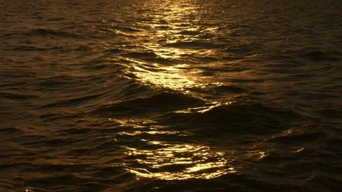 Golden Ocean Water Waves Surface Reflection at Sunset Stock Footage 317684638