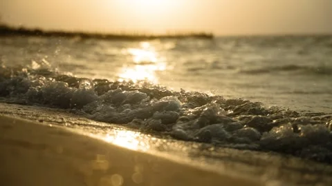 Golden Ocean Waves on Sandy Beach at Sunset or Sunrise Stockbeeldmateriaal 308670056