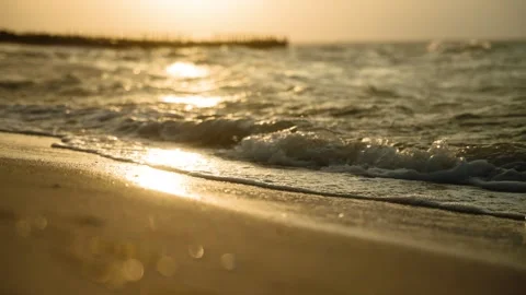 Golden Ocean Waves on Sandy Beach at Sunset or Sunrise Stockbeeldmateriaal 308670060