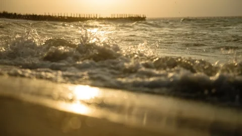 Golden Ocean Waves on Sandy Beach at Sunset or Sunrise Stockbeeldmateriaal 308670065