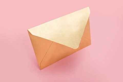 Golden paper envelope isolated on pink background Stock Photos