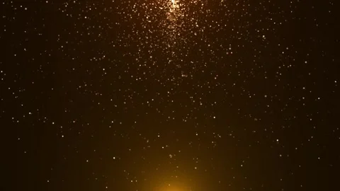 Golden particles falling gently in dark space creating a warm sparkling rain 库存影片 330593617