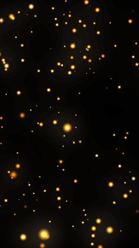 Golden particles float gracefully against a black backdrop Video stock 311804679