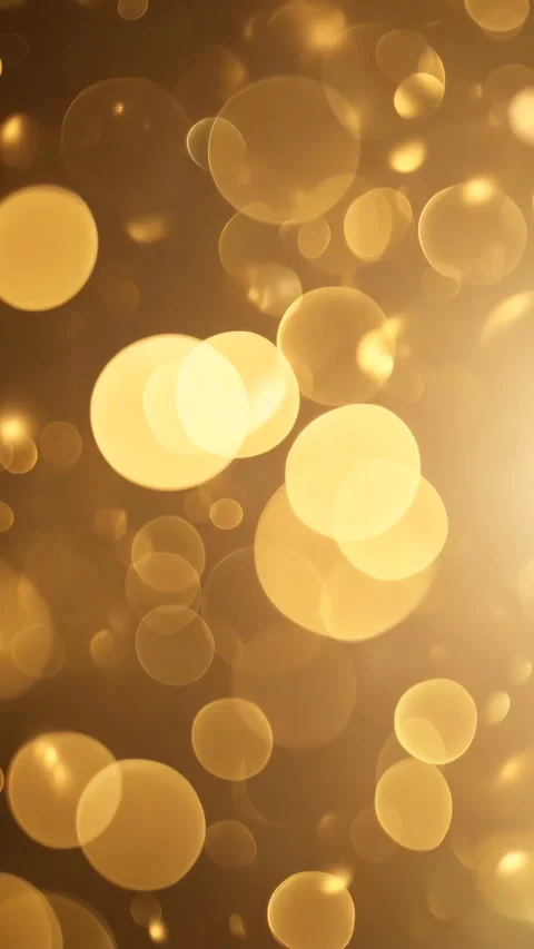 Golden particles floating gently creating a magical bokeh effect. Vertical video Stock Footage 310228822