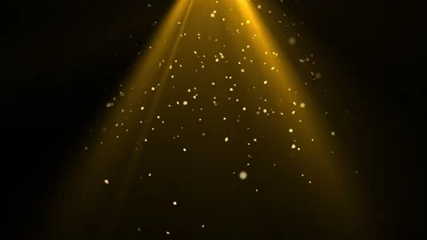 Golden particles gracefully float in warm spotlight beams on a dark Stock Footage 313278116