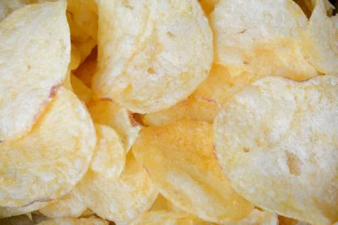 Golden potato crisps closeup - background Stock Photos